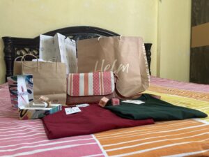 A woman shopping for branded clothes, handbags, and shoes — spending ₹10,000 – ₹12,000 monthly on fashion.