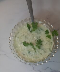 Cooling Cucumber Yogurt topped with a sprinkle of salt and optional cumin or mint for flavor.