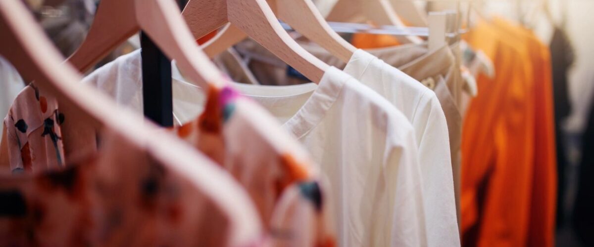 Different colored clothes neatly hung on hangers, showcasing versatile wardrobe essentials for mix-and-match outfit ideas.
