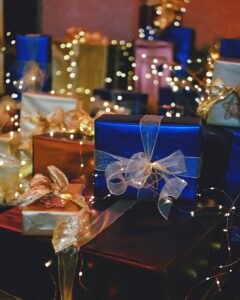An assortment of gifting essentials including gift boxes, ribbons, candles, and decorative items arranged neatly, perfect for festive or special occasions.