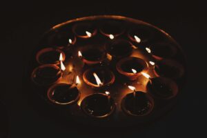 Lit diyas and arranged beautifully, casting a warm, festive glow in a cozy home setting.