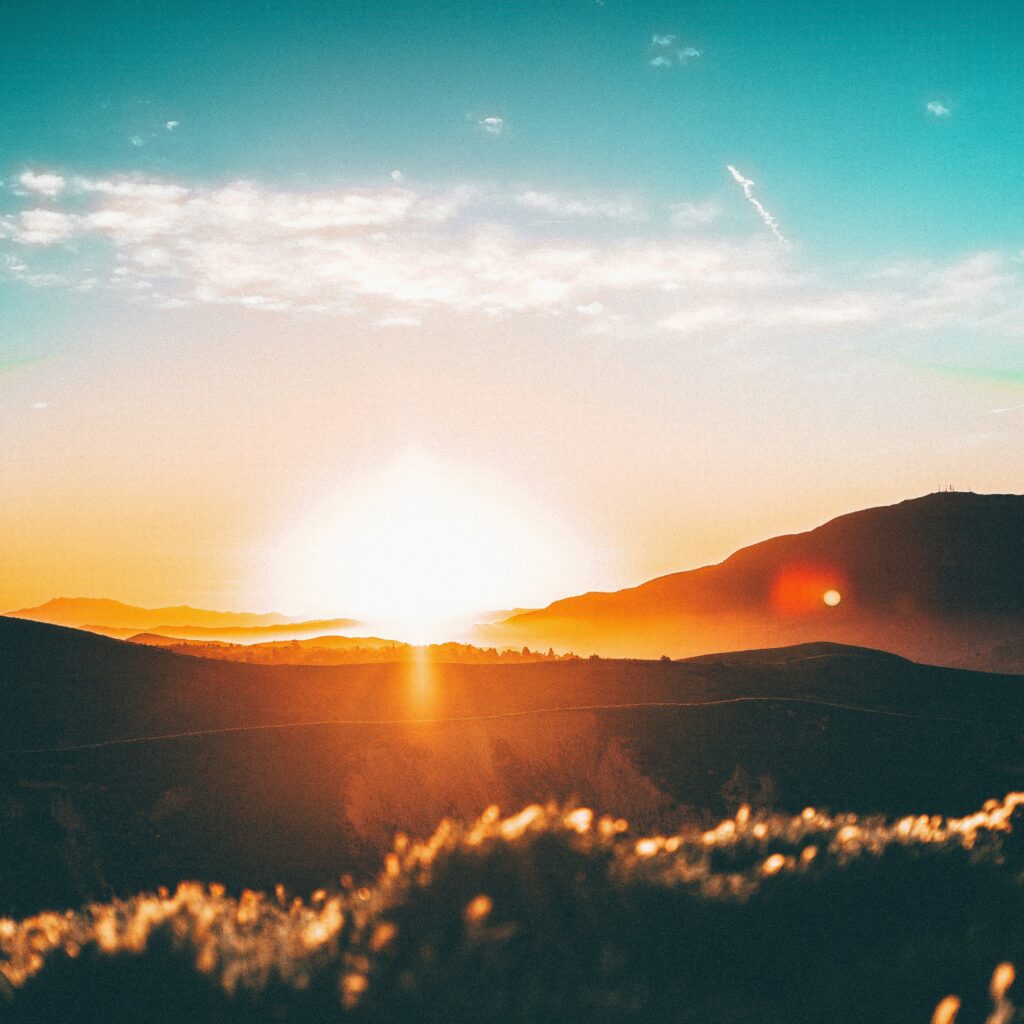 Bright and golden sunrise sky representing the quiet and fresh beginning of a summer morning routine