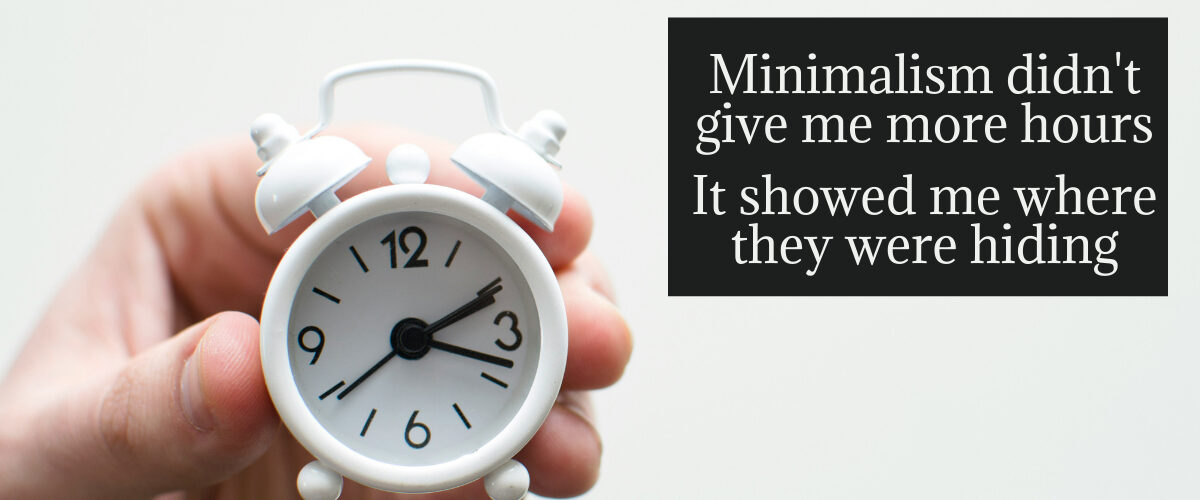 Hand holding a white alarm clock with a quote about minimalism and finding more time through intentional living.