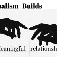 Minimalist black-and-white image of two hands reaching toward each other, symbolizing how minimalism helps build meaningful relationships through deeper human connection.