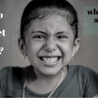 Angry child reacting after a parent takes away a smartphone, illustrating the impact of screen time and digital minimalism in kids.