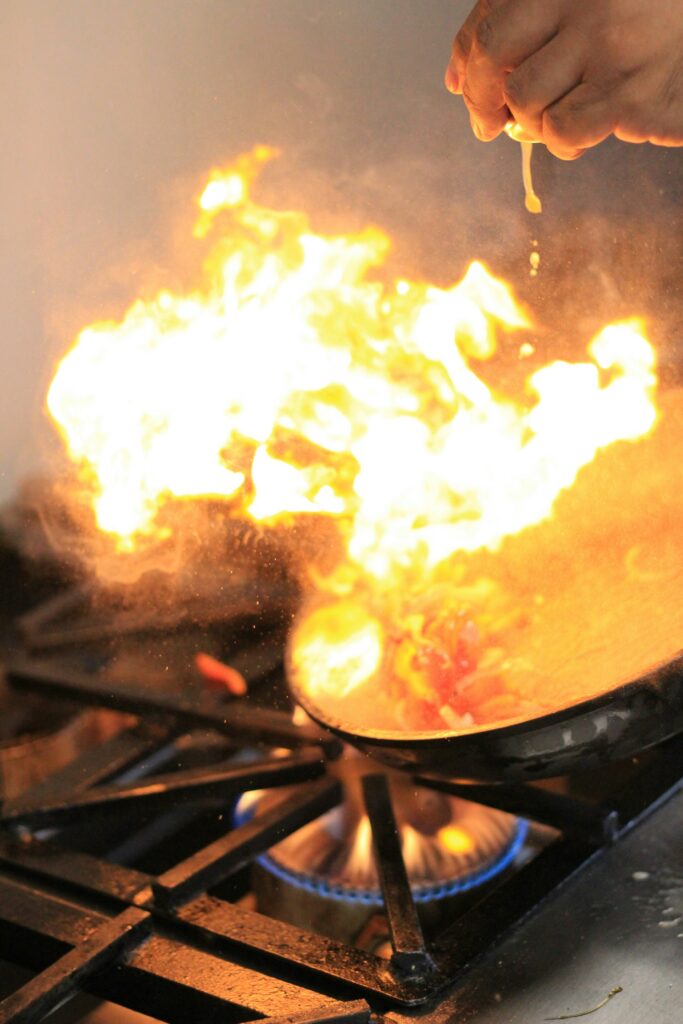 Cast iron skillet on a gas stove with high flames underneath