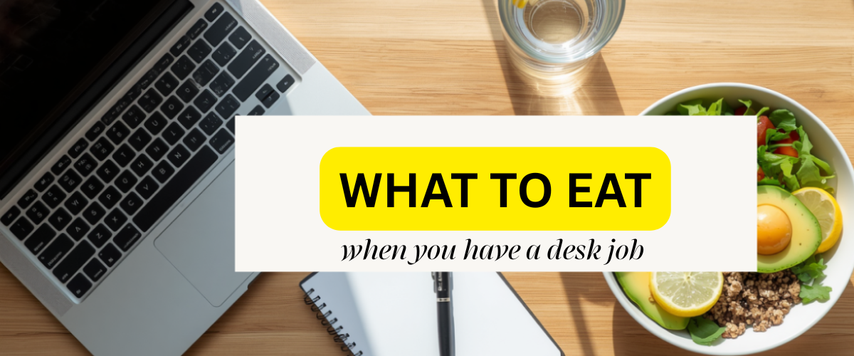 A minimalist wooden office desk with a laptop, a healthy meal bowl, and a glass of water, representing healthy eating habits for a desk job.